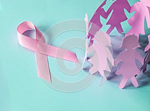 The Sweet pink ribbon shape with girl paper doll on blue background for Breast Cancer Awareness symbol to promote in october mo