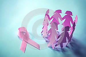 The Sweet pink ribbon shape with girl paper doll on blue background for Breast Cancer Awareness symbol to promote in october mo