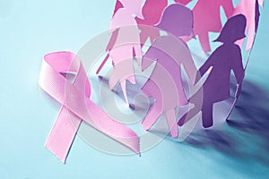 The Sweet pink ribbon shape with girl paper doll on blue background for Breast Cancer Awareness symbol to promote in october mo