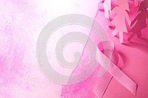 The Sweet pink ribbon shape with girl paper doll on pink background for Breast Cancer Awareness symbol to promote in october mo