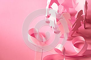 The Sweet pink ribbon shape with girl paper doll on pink background for Breast Cancer Awareness symbol to promote in october mo