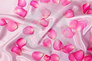 Sweet pink roses petal on soft pink silk fabric , romance and