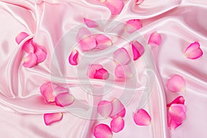 sweet pink roses petal on soft pink silk fabric , romance and