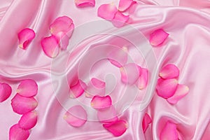 the sweet pink roses petal on soft pink silk fabric , romance