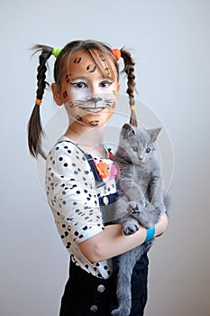 Sweet portrait of a cute little girl with a cat