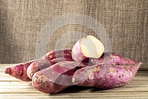Sweet potato in basket on jute background