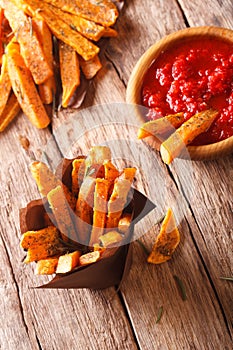 Sweet potato fries with rosemary, and ketchup close-up. Vertical