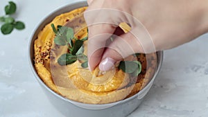 Sweet potato hummus or pumpkin dip in a gray bowl