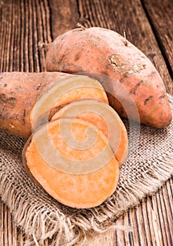 Sweet Potato (uncooked) on wooden background