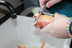 Sweet potatoe being peeled