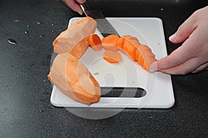 Sweet potatoe and carrot on a chopping board