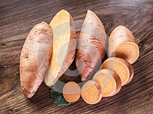Sweet potatoes on the old wooden table.