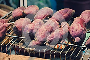 Sweet potatoes roast on the fireplace.