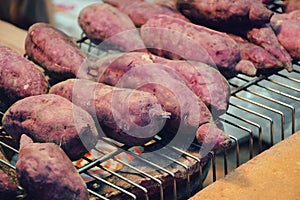 Sweet potatoes roast on the fireplace.