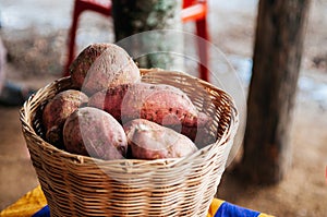 Sweet potatoes or yam in wooden basket, asian farming product