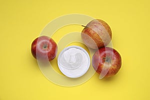 Sweet powdered fructose and apples on yellow background, flat lay