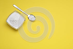 Sweet powdered fructose on yellow background, flat lay. Space for text