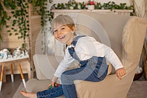 Sweet preschool boy in studio, playing with, egg for Easter and eating chocolate, child on Easter holiday