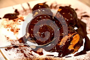 Sweet profitterol pie with chocolate cream and cocoa