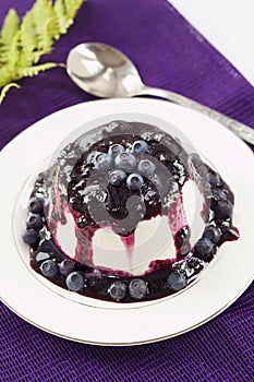 Sweet pudding with blueberry confiture
