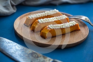 Sweet pumpkin dessert with cream cheese. Healthy tasty eastern food on the plate. sweet dessert with topping