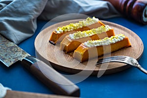 Sweet pumpkin dessert with cream cheese. Healthy tasty eastern food on the plate. sweet dessert with topping.