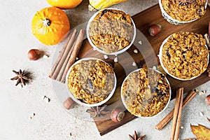 Sweet pumpkin vegan muffins with fall spices on wooden board. Autumn dessert. Healthy baking concept. Top view