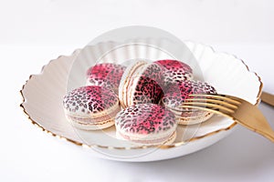 Sweet raspberry and vanilla macaroons on plate