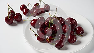 Sweet red cherries on a plate, fresh ripe sour cherries