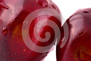 Sweet red cherry with water drops macro photo on white background.