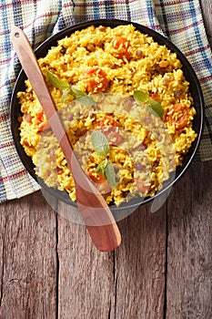 Sweet rice with dried apricots and raisins close-up. vertical to