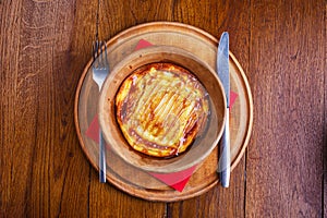 Sweet rice pudding baked in pottery with fork and knife photo