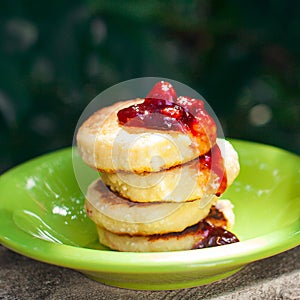 Sweet ricotta pancakes with jam, closeup, selective focus