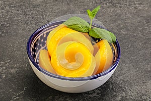 Sweet ripe canned peaches with mint