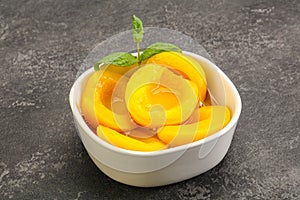 Sweet ripe canned peaches with mint