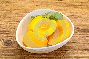 Sweet ripe canned peaches with mint