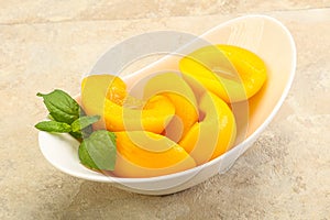 Sweet ripe canned peaches with mint