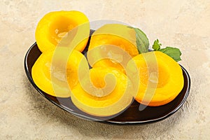 Sweet ripe canned peaches with mint