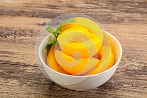 Sweet ripe canned peaches with mint