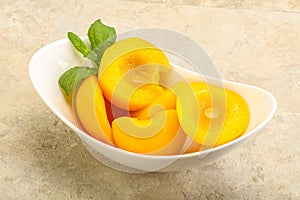 Sweet ripe canned peaches with mint