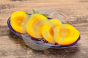 Sweet ripe canned peaches with mint