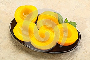 Sweet ripe canned peaches with mint