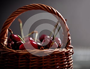 Sweet ripe cherries in basket close up.