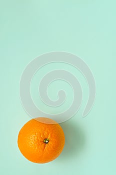 Sweet ripe juicy fresh orange on a mint background in the shape of a switch toggle switch. One whole orange fruit. citrus healthy