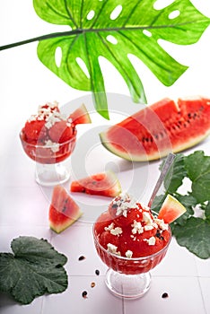 Sweet ripe summer watermelon on slices and as a dessert in a cup with feta cheese