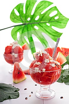 Sweet ripe summer watermelon on slices and as a dessert in a cup with feta cheese