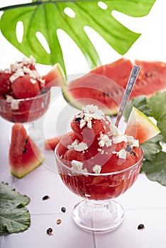 Sweet ripe summer watermelon on slices and as a dessert in a cup with feta cheese