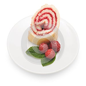 Sweet roll cake with raspberry jam and berries, isolated on a white