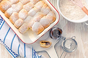 Sweet rolls, Buchteln filled with plum jam or jelly with backing ingredients