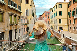 Sweet romantic girl charmed by Venice landscape. Rear view of fe